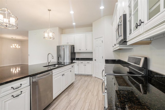 212 Shell Creek Ct, Apollo Beach, FL 33572 - kitchen featuring stainless steel appliances, a sink, a chandelier, white cabinets, and recessed lighting