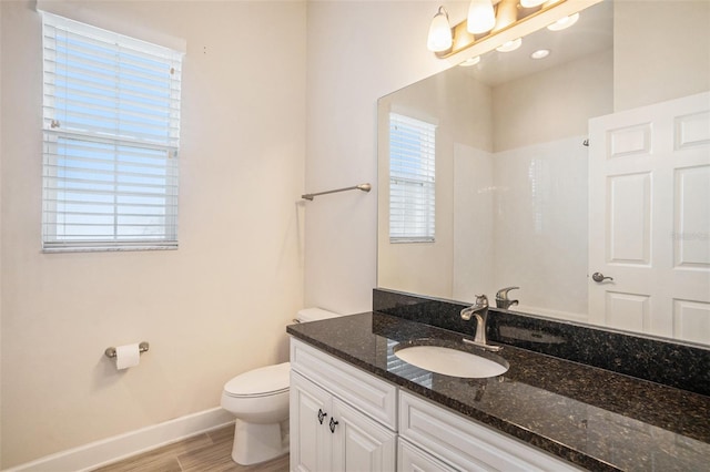 212 Shell Creek Ct, Apollo Beach, FL 33572 - bathroom featuring toilet, vanity, baseboards, and wood finished floors