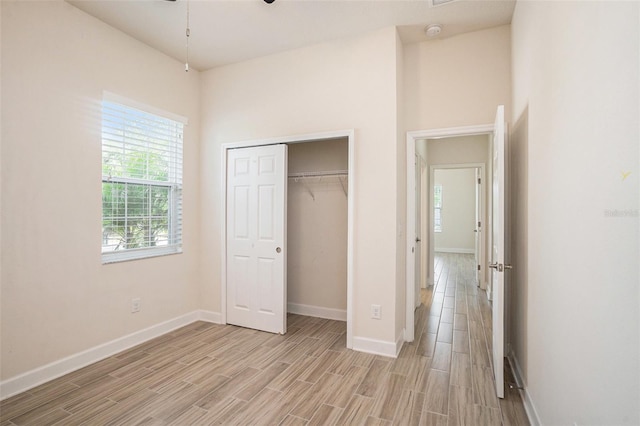 212 Shell Creek Ct, Apollo Beach, FL 33572 - unfurnished bedroom featuring light wood-style flooring, baseboards, and a closet