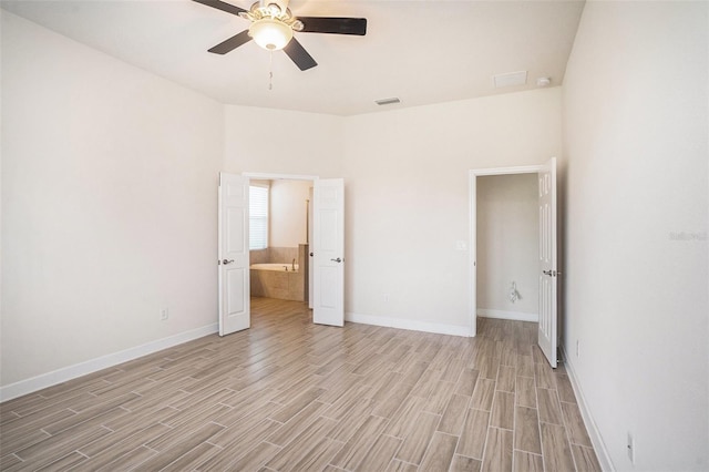212 Shell Creek Ct, Apollo Beach, FL 33572 - unfurnished bedroom with light wood finished floors, baseboards, a ceiling fan, and connected bathroom