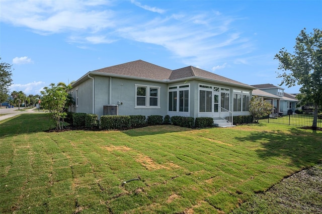 212 Shell Creek Ct, Apollo Beach, FL 33572 - rear view of house featuring entry steps, a sunroom, stucco siding, and a shingled roof