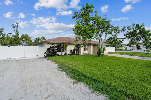2204 78th St W, Bradenton, FL 34209 - view of front of house with driveway, stucco siding, an attached garage, and a gate