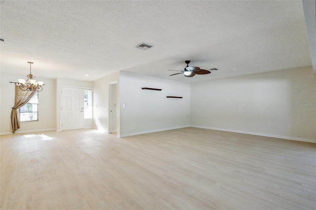2204 78th St W, Bradenton, FL 34209 - unfurnished room with a ceiling fan, light wood-style flooring, a chandelier, a textured ceiling, and baseboards