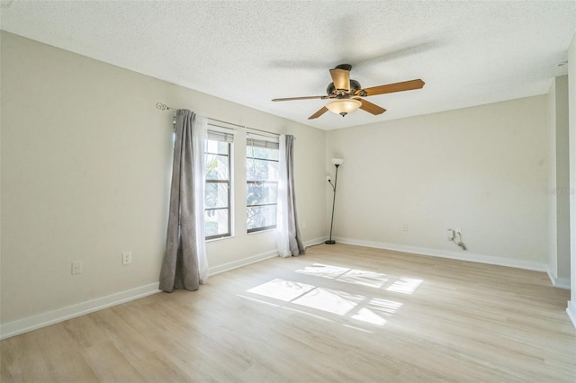 2204 78th St W, Bradenton, FL 34209 - empty room featuring light wood-style flooring, a ceiling fan, baseboards, and a textured ceiling