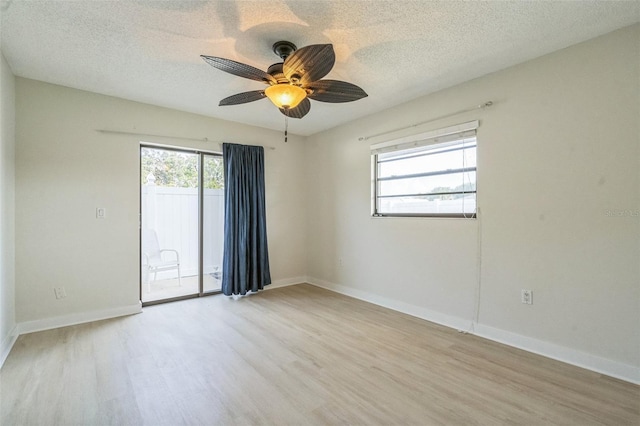 2204 78th St W, Bradenton, FL 34209 - empty room featuring light wood-style flooring, a textured ceiling, ceiling fan, and baseboards