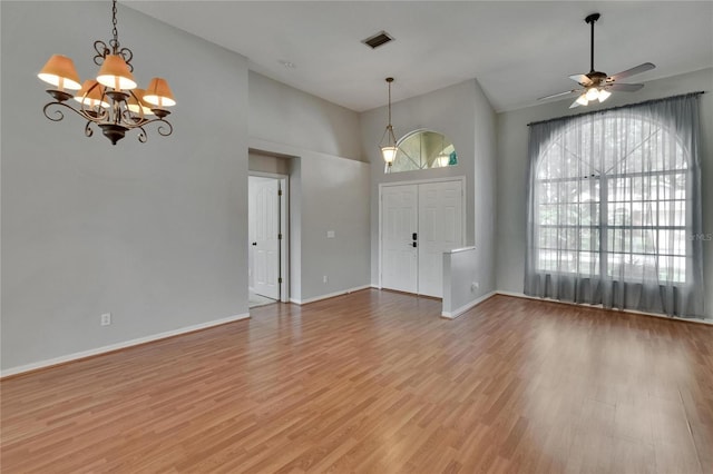 4418 River Overlook Dr, Valrico, FL 33596 - unfurnished living room featuring a chandelier, light wood-style flooring, a ceiling fan, baseboards, and high vaulted ceiling