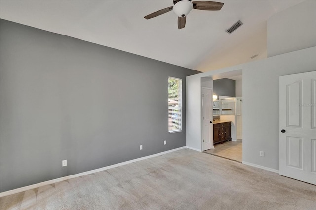 4418 River Overlook Dr, Valrico, FL 33596 - unfurnished bedroom featuring light carpet, baseboards, vaulted ceiling, ensuite bath, and a ceiling fan