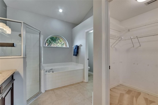 4418 River Overlook Dr, Valrico, FL 33596 - bathroom featuring a garden tub, a walk in closet, a stall shower, and vanity