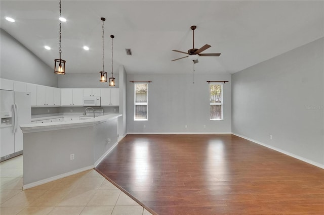 4418 River Overlook Dr, Valrico, FL 33596 - kitchen with white appliances, a ceiling fan, light countertops, white cabinetry, and pendant lighting