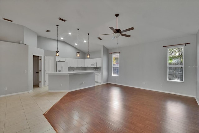 4418 River Overlook Dr, Valrico, FL 33596 - unfurnished living room featuring ceiling fan, plenty of natural light, high vaulted ceiling, and baseboards