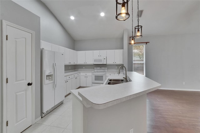 4418 River Overlook Dr, Valrico, FL 33596 - kitchen with white appliances, a sink, light countertops, lofted ceiling, and pendant lighting