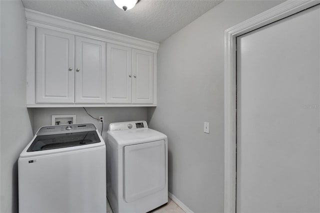 4418 River Overlook Dr, Valrico, FL 33596 - laundry room featuring washer and dryer, cabinet space, a textured ceiling, and baseboards