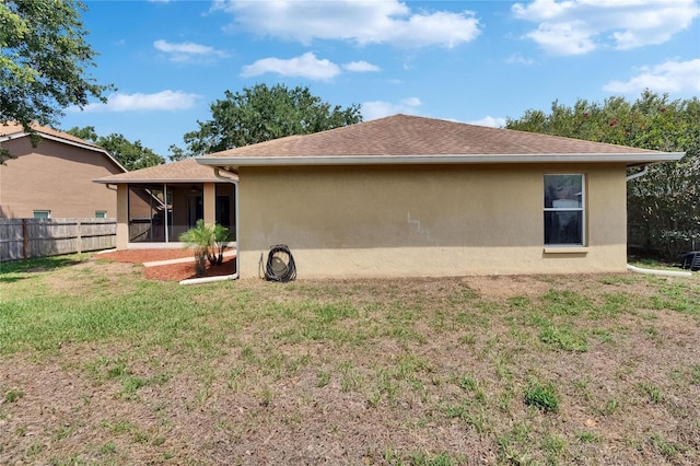 4418 River Overlook Dr, Valrico, FL 33596 - back of property featuring a sunroom, stucco siding, and roof with shingles