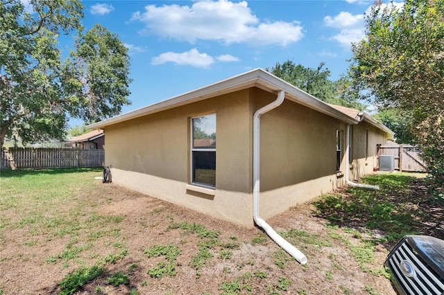 4418 River Overlook Dr, Valrico, FL 33596 - view of side of home featuring stucco siding and central AC unit