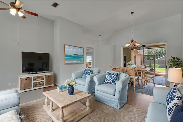 4418 River Overlook Dr, Valrico, FL 33596 - living area featuring a chandelier, ceiling fan, wood finished floors, and high vaulted ceiling