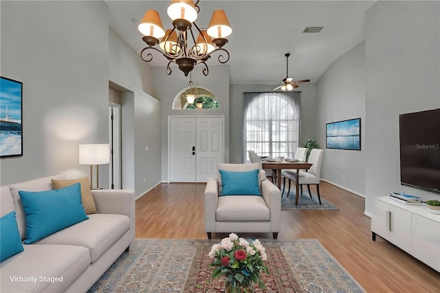 4418 River Overlook Dr, Valrico, FL 33596 - living area featuring high vaulted ceiling, a chandelier, wood finished floors, and a ceiling fan