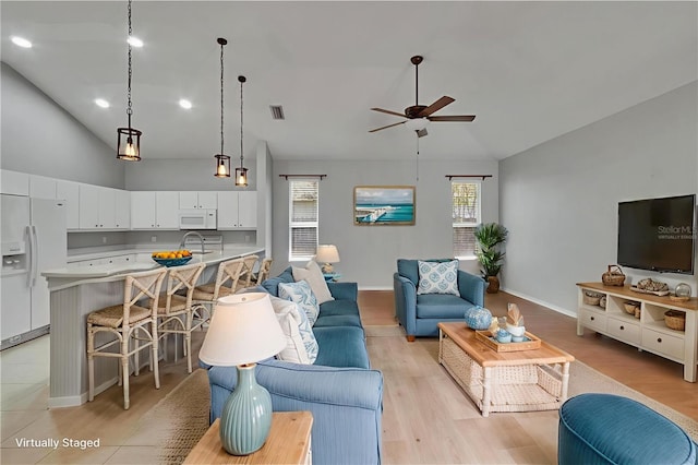 4418 River Overlook Dr, Valrico, FL 33596 - living room featuring ceiling fan, light wood-style floors, high vaulted ceiling, and recessed lighting