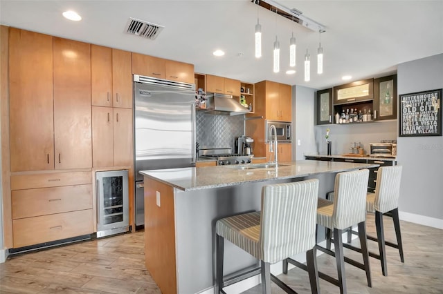 1120 E Kennedy Blvd Unit 1512, Tampa, FL 33602 - kitchen featuring beverage cooler, open shelves, under cabinet range hood, built in appliances, and recessed lighting