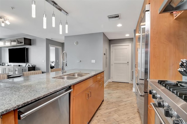 1120 E Kennedy Blvd Unit 1512, Tampa, FL 33602 - kitchen featuring stainless steel dishwasher, a sink, stone counters, hanging light fixtures, and under cabinet range hood