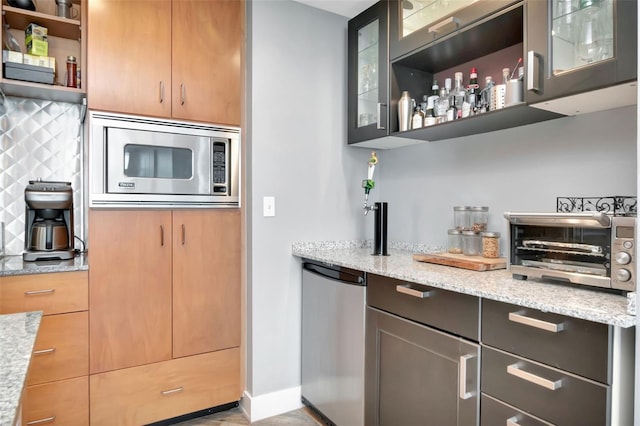 1120 E Kennedy Blvd Unit 1512, Tampa, FL 33602 - kitchen with appliances with stainless steel finishes, open shelves, light stone countertops, baseboards, and backsplash