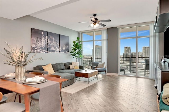 1120 E Kennedy Blvd Unit 1512, Tampa, FL 33602 - living area with a ceiling fan, wood finished floors, floor to ceiling windows, and a skyline view
