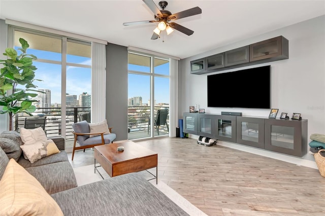 1120 E Kennedy Blvd Unit 1512, Tampa, FL 33602 - living area with floor to ceiling windows, a ceiling fan, and light wood-style floors