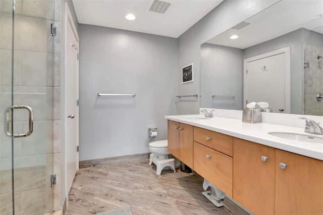 1120 E Kennedy Blvd Unit 1512, Tampa, FL 33602 - full bath featuring double vanity, a stall shower, wood finished floors, toilet, and recessed lighting