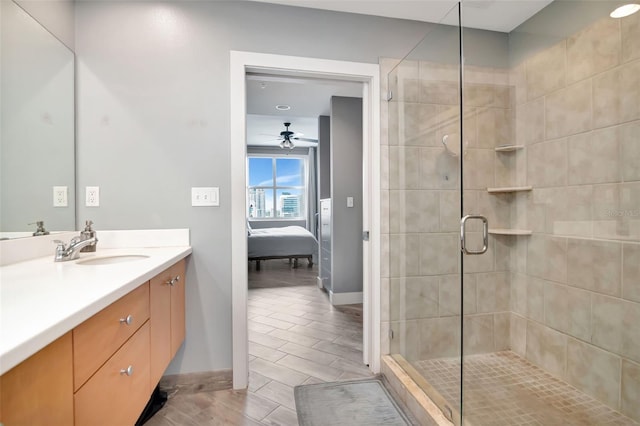 1120 E Kennedy Blvd Unit 1512, Tampa, FL 33602 - ensuite bathroom featuring vanity, a shower stall, baseboards, a ceiling fan, and wood finish floors