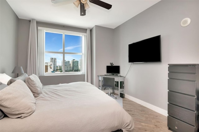 1120 E Kennedy Blvd Unit 1512, Tampa, FL 33602 - bedroom with light wood finished floors, baseboards, and ceiling fan