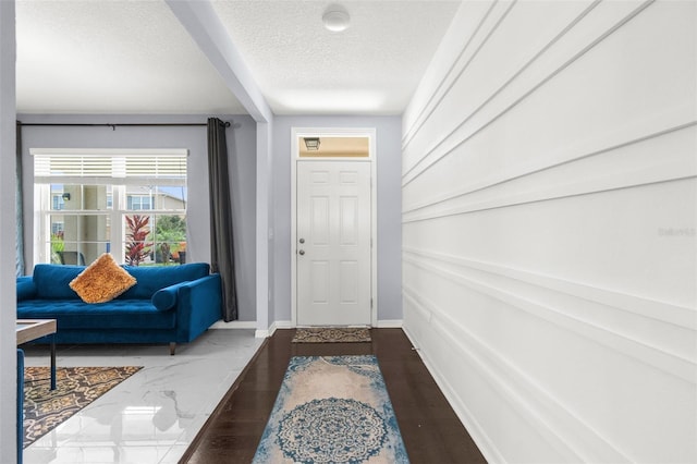 30936 Summer Sun Loop, Wesley Chapel, FL 33545 - doorway with a textured ceiling and baseboards