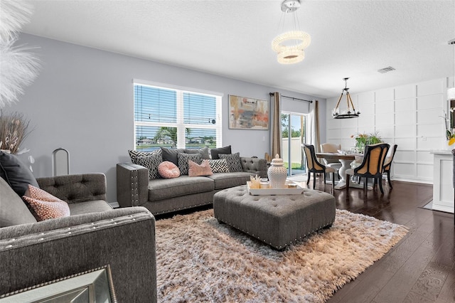 30936 Summer Sun Loop, Wesley Chapel, FL 33545 - living area with a chandelier, dark wood-style flooring, and a textured ceiling