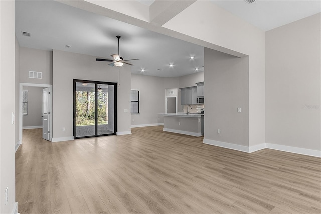 2402 Hiers Rd, Dover, FL 33527 - unfurnished living room featuring a sink, light wood-style flooring, ceiling fan, baseboards, and recessed lighting