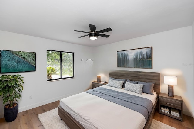 1161 Orangewood Ave, Deland, FL 32724 - bedroom featuring baseboards, wood finished floors, and a ceiling fan