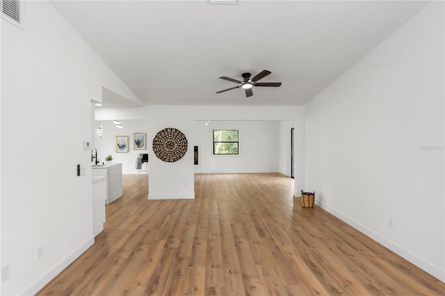 1161 Orangewood Ave, Deland, FL 32724 - unfurnished living room featuring light wood-type flooring, a ceiling fan, and baseboards