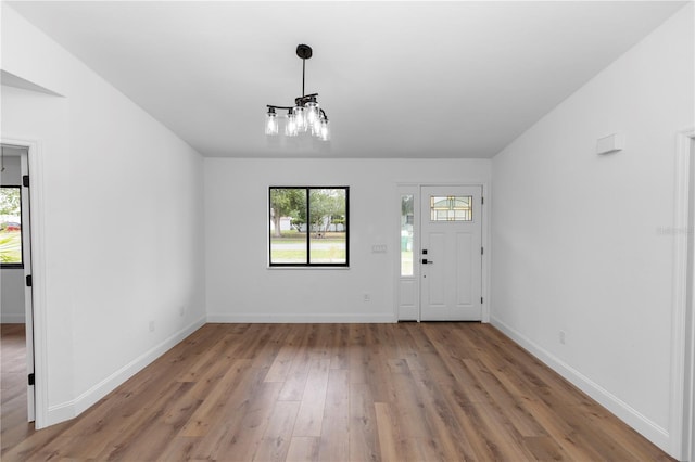 1161 Orangewood Ave, Deland, FL 32724 - entryway featuring a chandelier, plenty of natural light, wood finished floors, and baseboards