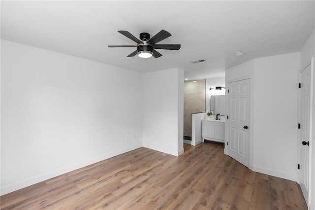 1161 Orangewood Ave, Deland, FL 32724 - unfurnished bedroom featuring light wood-style flooring, baseboards, a ceiling fan, and ensuite bath