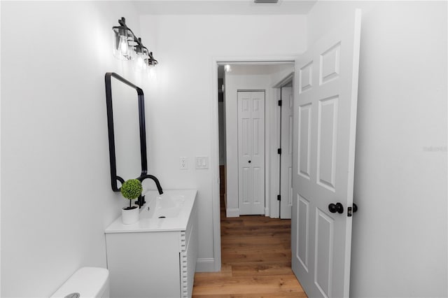 1161 Orangewood Ave, Deland, FL 32724 - bathroom featuring vanity, wood finished floors, and toilet