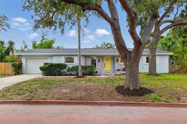 1470 Serpentine Dr S, Saint Petersburg, FL 33705 - view of front of home featuring a garage, concrete driveway, and stucco siding