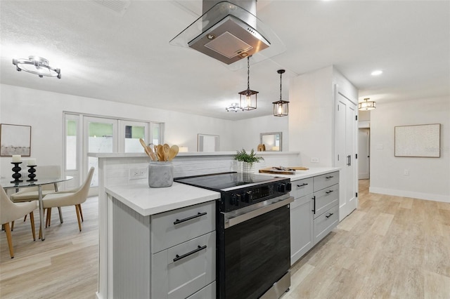 1470 Serpentine Dr S, Saint Petersburg, FL 33705 - kitchen with range with electric stovetop, exhaust hood, light countertops, light wood-type flooring, and recessed lighting