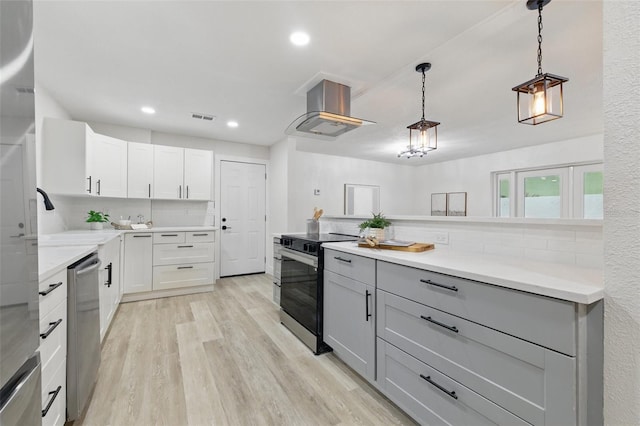 1470 Serpentine Dr S, Saint Petersburg, FL 33705 - kitchen featuring stainless steel appliances, island exhaust hood, gray cabinets, light wood-style flooring, and decorative backsplash