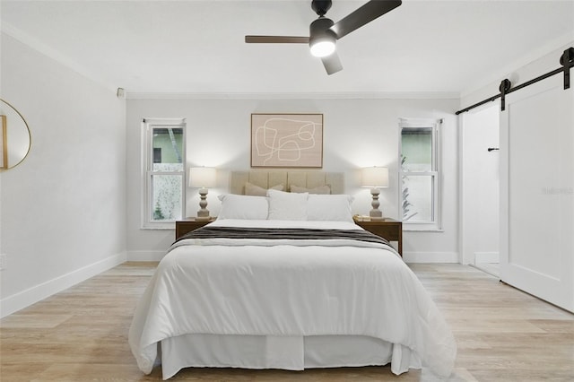 1470 Serpentine Dr S, Saint Petersburg, FL 33705 - bedroom with a barn door, ornamental molding, wood finished floors, and baseboards
