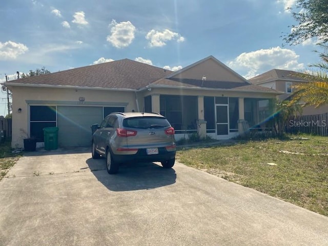 1720 SW Cameo Blvd, Port St Lucie, FL 34953 - ranch-style house with concrete driveway, a front lawn, an attached garage, and stucco siding