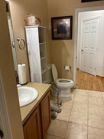 1720 SW Cameo Blvd, Port St Lucie, FL 34953 - bathroom with vanity, toilet, and tile patterned floors