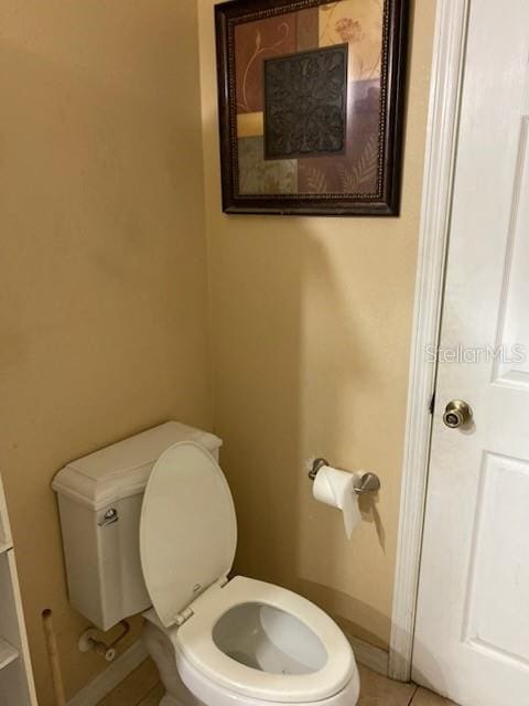 1720 SW Cameo Blvd, Port St Lucie, FL 34953 - bathroom with toilet, tile patterned floors, and baseboards