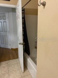 1720 SW Cameo Blvd, Port St Lucie, FL 34953 - bathroom featuring tile patterned flooring and shower / tub combo