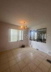 1720 SW Cameo Blvd, Port St Lucie, FL 34953 - unfurnished living room featuring a chandelier