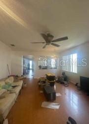 1720 SW Cameo Blvd, Port St Lucie, FL 34953 - living area with a ceiling fan and wood finished floors
