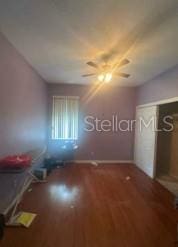 1720 SW Cameo Blvd, Port St Lucie, FL 34953 - unfurnished bedroom with wood finished floors and a closet