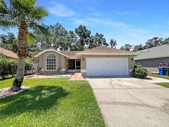 8812 Bayaud Dr, Tampa, FL 33626 - single story home with stucco siding, concrete driveway, an attached garage, and a front lawn
