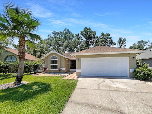 8812 Bayaud Dr, Tampa, FL 33626 - ranch-style home with stucco siding, a garage, driveway, and a front yard